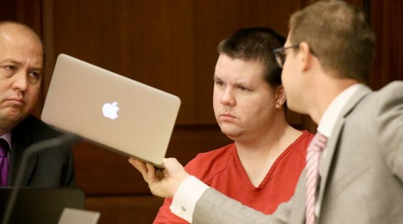 Justin Ross Harris confers with his attorneys during a recent motions hearing (File photo)