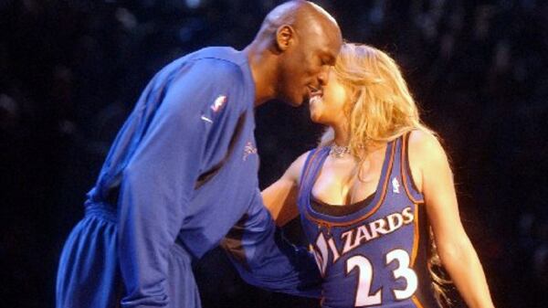 Michael Jordan embraces singer Mariah Carey during the halftime show of the 2003 NBA All Star Game in Atlanta Sunday, Feb. 9, 2003 at Philips Arena. (PHOTO BY T. LEVETTE BAGWELL/STAFF)