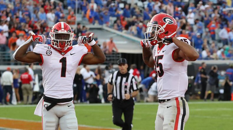 Georgia wide receivers Lawrence Cager (right) and teammate George Pickens flex.   Curtis Compton/ccompton@ajc.com