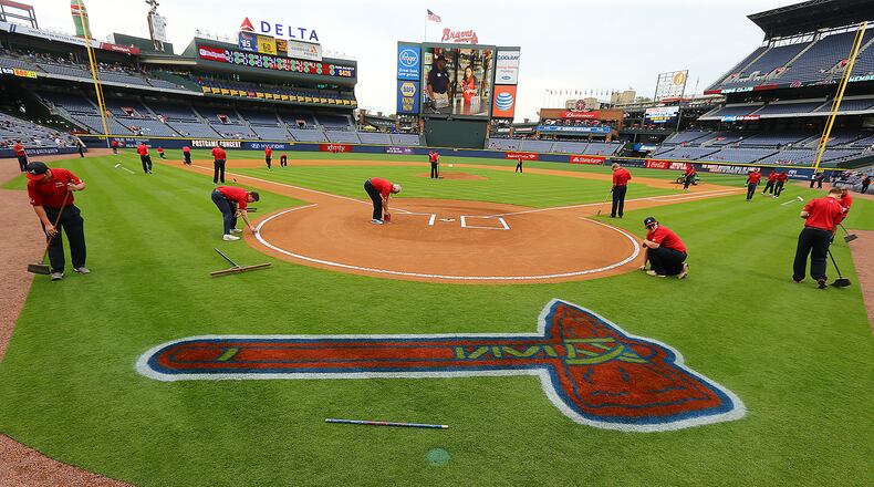 The Braves ground crew prepares Turner Field for a 10-game homestand as the Braves prepare to battle the Nationals in the first game of a three-game series and the first of 19 meetings between the two clubs this season on Monday, April 27, 2015, in Atlanta. Curtis Compton / ccompton@ajc.com