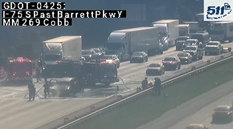 A car fire closed northbound lanes on I-75 just before the exit to Barrett Parkway on Monday morning. Traffic was blocked as crews cleaned up the aftermath, though at least one lane has since reopened. (Georgia Department of Transportation)