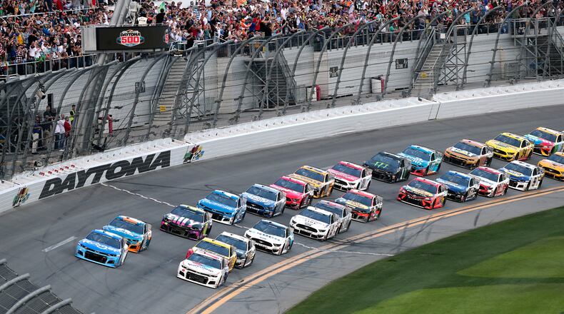 Ricky Stenhouse Jr. (front left) and Alex Bowman (front right) lead the field to start the NASCAR Daytona 500 auto race at Daytona International Speedway, Sunday, Feb. 16, 2020, in Daytona Beach, Fla.
