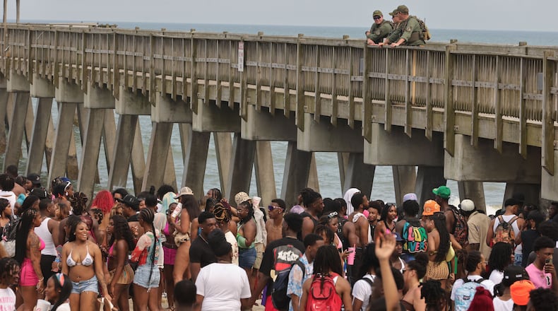 Game wardens from the Georgia Department of Natural Resources patrol from Tybee Island Pier as attendees of Orange Crush party on the beach in April 2024. Tybee officials have issued a special use permit for the 2025 spring break gathering for college students. (Natrice Miller/ AJC)
