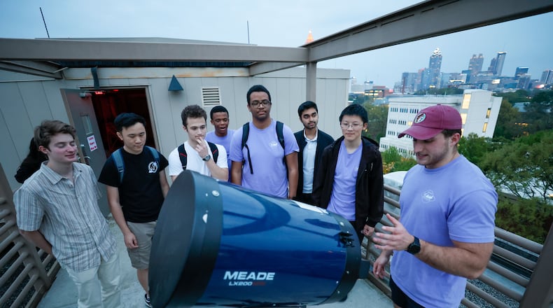 Ethan Atkinson (right), president of the Georgia Tech Astronomy Club, speaks to club members as he shows the new telescope the school acquired for the astrophysics lab on Monday, April 1, 2024. For the eclipse viewing trip, the club plans to bring along astrophotography gear and an 8-inch Celestron telescope with a solar filter for members to use. (Miguel Martinez /miguel.martinezjimenez@ajc.com)