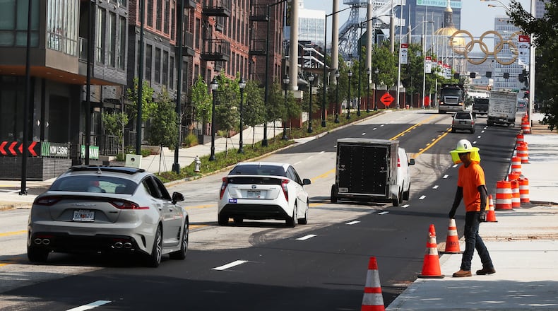 The Olympic cauldron and rings sit in the distance beside the recently built 565 Hank apartments in Summerhill on August 2, 2021, in Atlanta. Curtis Compton / Curtis.Compton@ajc.com