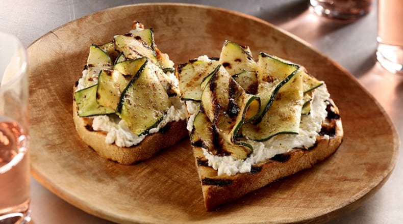For a light summery lunch or simple appetizer, grill up some rustic bread, slather it with garlic-oil doused ricotta and top with grilled zucchini ribbons. (Michael Tercha/Chicago Tribune/TNS)