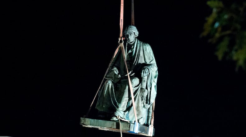 Workers use a crane to lift the monument dedicated to U.S. Supreme Court Chief Justice Roger Brooke Taney after it was removed from outside the Maryland state Capitol in Annapolis early Friday. AP/Jose Luis Magana