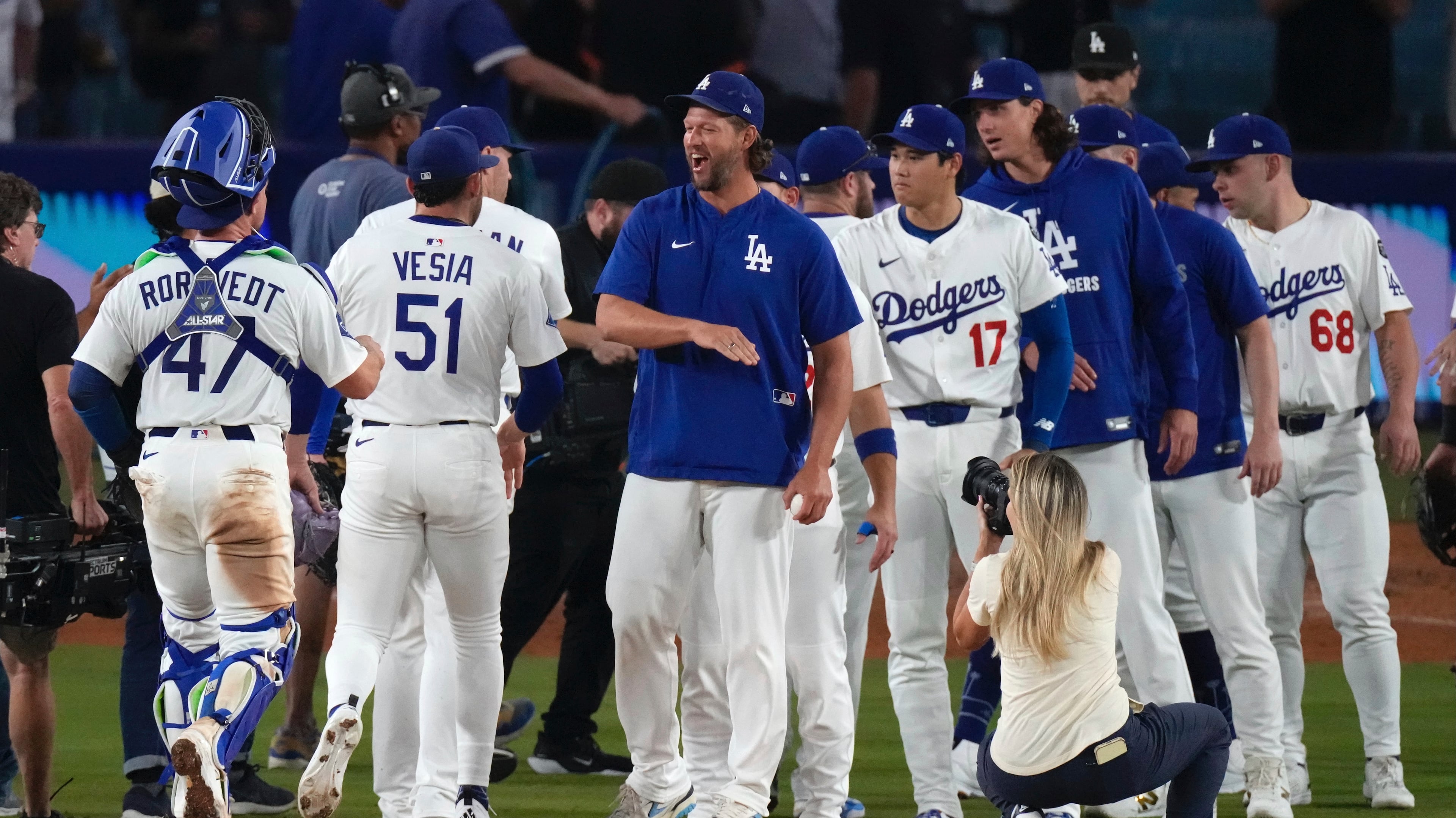 Los Angeles Dodgers' Clayton Kershaw, center, congratulates members of his team after the Dodgers defeated the San Francisco Giants in a baseball game Thursday, Sept. 18, 2025, in Los Angeles. (AP Photo/Mark J. Terrill)