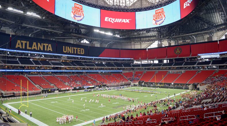 Brookwood and McEachern football teams warm up before the start of their  Corky Kell Classic game Saturday, Aug. 24, 2019, at the Mercedes Benz-Stadium in Atlanta.