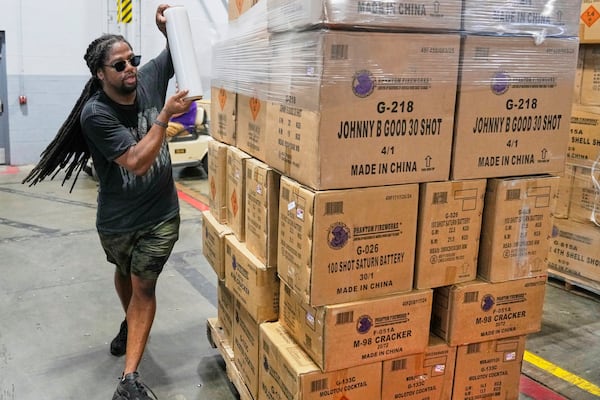 Lamar Teague wraps boxes of fireworks for shipping at the Phantom Fireworks warehouse in Warren, Ohio Wednesday, June 25, 2025. (AP Photo/Sue Ogrocki)