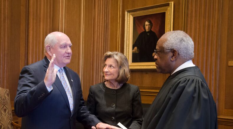 Flanked by his wife, Mary, former Georgia Gov. Sonny Perdue is sworn in as the 31st secretary of agriculture by Supreme Court Justice and Georgia native Clarence Thomas. PHOTO: With permission from USDA/Cabinet Communications.