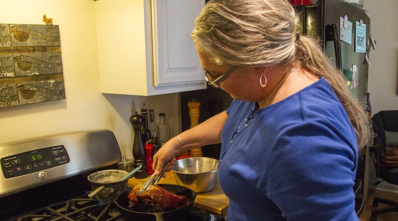 Virginia Willis, a southern chef, prepares a meal at her home in Vinings, Georgia, on Thursday, April 26, 2018. Willis will be releasing her new cookbook, Southern Table: A Food Lover’s Tour of the Global South, on April 30. (REANN HUBER/REANN.HUBER@AJC.COM)