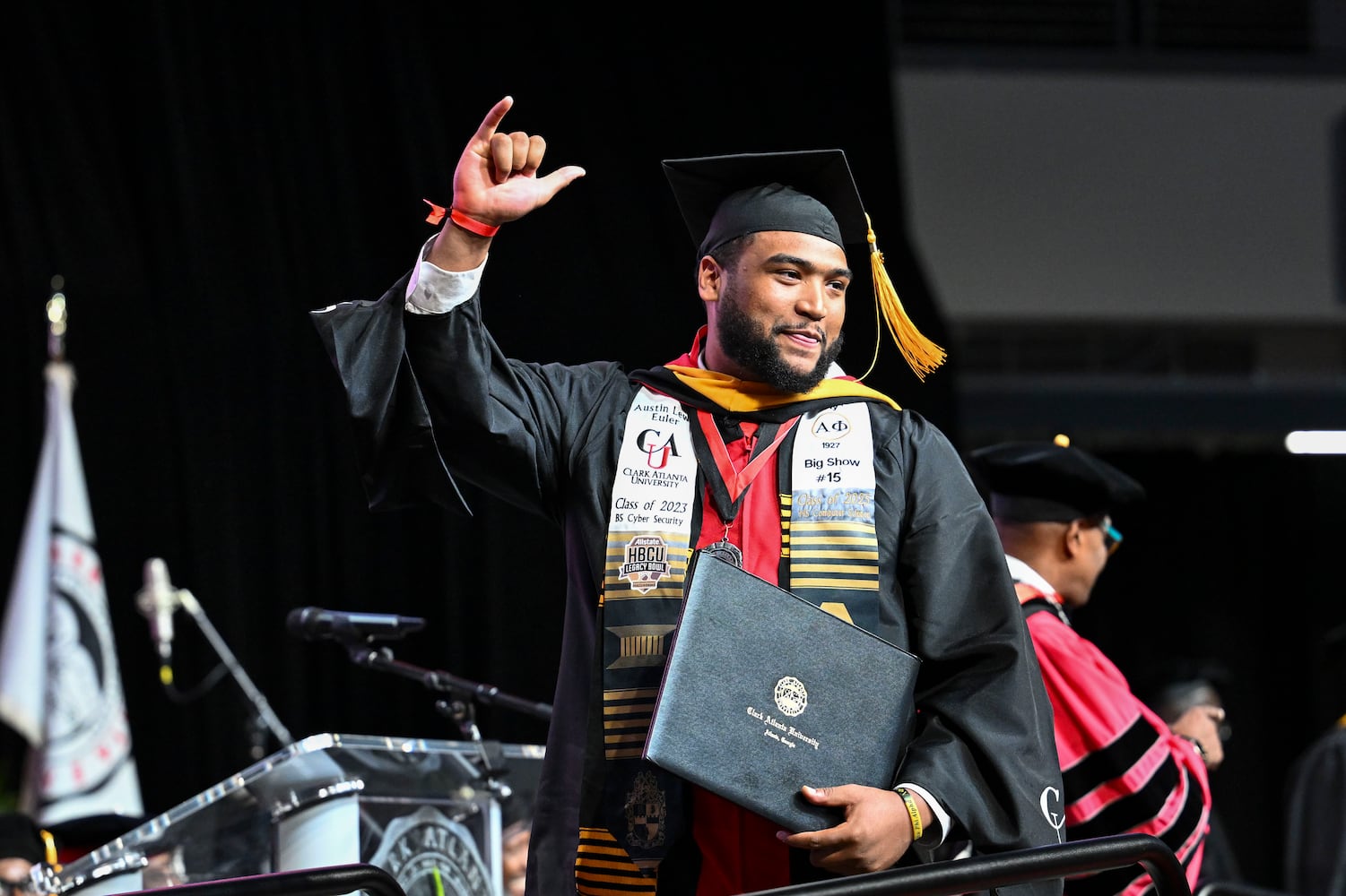 Austin Euler gestures as he walks across the stage during Clark Atlanta University’s 2025 commencement ceremony Sunday, May 18, 2025 at Georgia State’s Convocation Center. (Daniel Varnado/For the Atlanta Journal-Constitution)