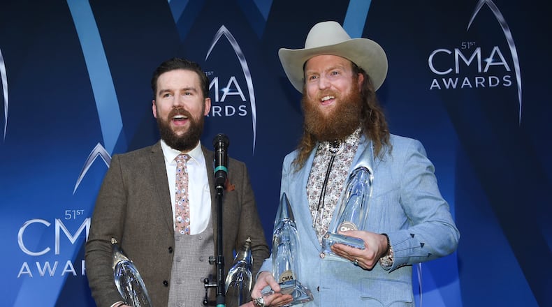 T.J., left, and John Osborne of the Brothers Osborne pose in the press room with their awards for vocal duo of the year and music video of the year at the 51st annual CMA Awards at the Bridgestone Arena on Wednesday, Nov. 8, 2017, in Nashville, Tenn. (Photo by Evan Agostini/Invision/AP)