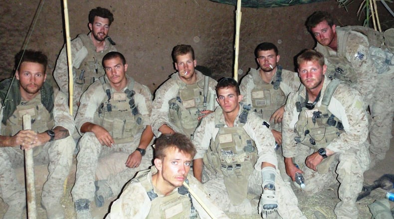 FILE PHOTO: U.S. Marines pose for a photo in Helmand province, Afghanistan, in June of 2010. Two members of the division recently hiked a mountain despite one of them losing both legs to an improvised explosive device.