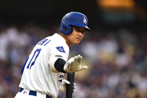 Los Angeles Dodgers' Shohei Ohtani gestures toward the Los Angeles Angels dugout before batting during the first inning of a baseball game Friday, May 16, 2025, in Los Angeles. (AP Photo/Mark J. Terrill)