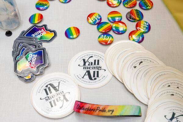 An assortments of stickers and pins were made available on a table for participants in the LGBTQ protest Monday at Georgia Southern University. (AJC Photo/Katelyn Myrick)