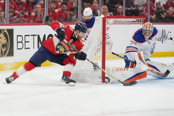 Edmonton Oilers goaltender Stuart Skinner (74) blocks a shot by Florida Panthers center Sam Bennett (9) during the second period of Game 6 of the NHL hockey Stanley Cup Final Tuesday, June 17, 2025, in Sunrise, Fla. (AP Photo/Lynne Sladky)