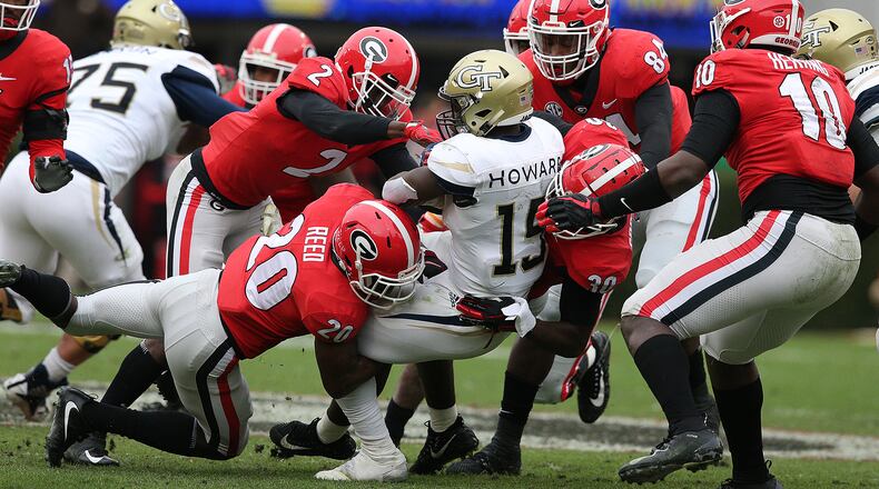 Nov 24, 2018 Athens: Georgia defenders gang tackle Georgia Tech runner Jerry Howard for a loss during the first half in their NCAA college football rivalry game on Saturday, Nov. 24, 2018, in Athens. Curtis Compton/ccompton@ajc.com