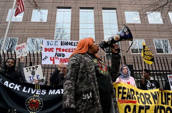 Protesters gather to protest federal agents presence in Minnesota outside ICE’s Atlanta Field Office, Friday, Jan. 23, 2026, in Atlanta. (Hyosub Shin/AJC)