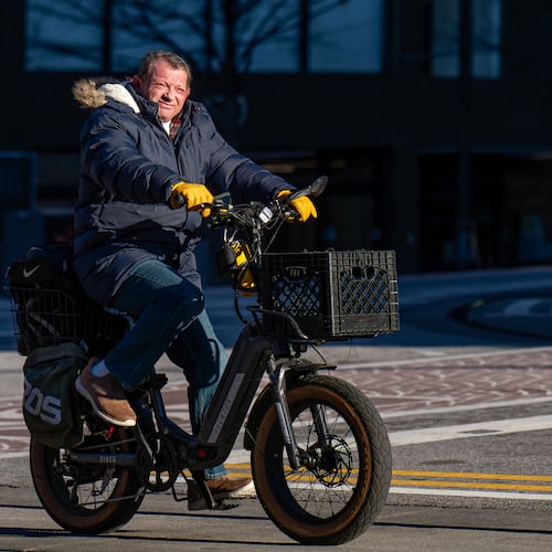 A man rides an electric bike in downtown Atlanta amid freezing temperatures Thursday, Jan. 15, 2026. There is potential for a winter wonderland in some parts of Georgia. (Ben Hendren for the AJC)