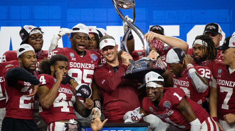 Oklahoma Sooners coach Lincoln Riley holds up the Cotton Bowl champions trophy and celebrates with his team during the postgame ceremony following the Goodyear Cotton Bowl Classic football game on Thursday, Dec. 30, 2020. (Lynda M. Gonzalez/The Dallas Morning News/TNS)