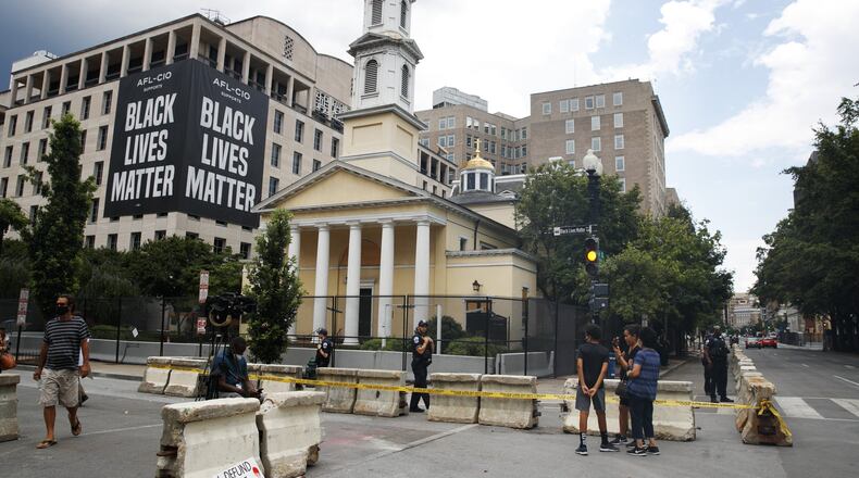 People visit the new police line at St. John’s Church, Thursday, June 25, 2020, in Washington, D.C., which has been the site of protests over the death of George Floyd, a black man who was in police custody in Minneapolis. Floyd died after being restrained by police officers. (AP Photo/Jacquelyn Martin)