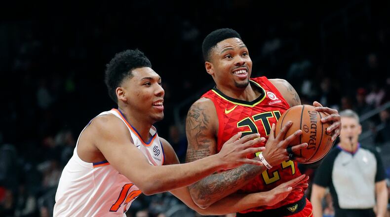 Hawks guard Kent Bazemore (24) drives against New York Knicks guard Allonzo Trier (14) during the first half of an NBA basketball game Thursday, Feb. 14, 2019, in Atlanta. (AP Photo/John Bazemore)