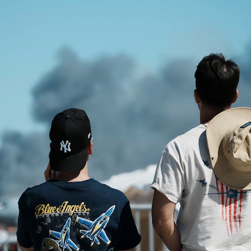 Spectators watch as smoke rises after a Hellenic Air Force F-4 Phantom fighter jet crashed, during the Athens Flying Week airshow at Tanagra Air Force Base, north of Athens, Greece, Saturday, Sept. 5, 2026. (AP Photo/Kallista Allaway)