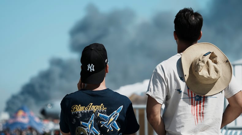 Spectators watch as smoke rises after a Hellenic Air Force F-4 Phantom fighter jet crashed, during the Athens Flying Week airshow at Tanagra Air Force Base, north of Athens, Greece, Saturday, Sept. 5, 2026. (AP Photo/Kallista Allaway)