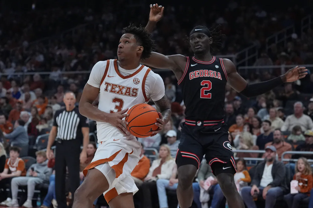 Texas guard Dailyn Swain (left) drives past Georgia center Somtochukwu Cyril during the second half of a game in Austin, Texas, Saturday, Jan. 24, 2026. (Eric Gay/AP)