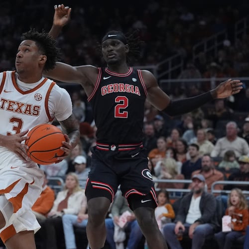 Texas guard Dailyn Swain (left) drives past Georgia center Somtochukwu Cyril during the second half of a game in Austin, Texas, Saturday, Jan. 24, 2026. (Eric Gay/AP)