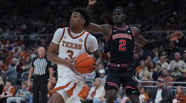 Texas guard Dailyn Swain (left) drives past Georgia center Somtochukwu Cyril during the second half of a game in Austin, Texas, Saturday, Jan. 24, 2026. (Eric Gay/AP)