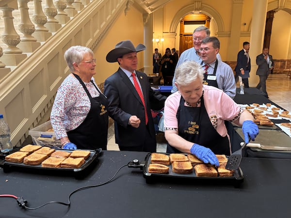 Georgia Agriculture Secretary Tyler Harper looked on as helpers for the Georgia Peanut Council served grilled peanut butter and jelly sandwiches at the Capitol in Atlanta on Tuesday. (Adam Beam/AJC)