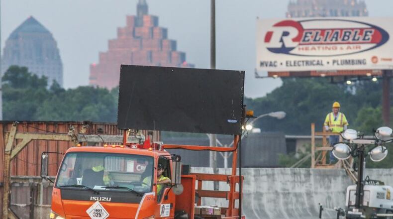 Construction crews were seen installing road reflectors on Friday morning May 12, 2017 as last-minute preparations for the reopening of I-85 in Atlanta continued. JOHN SPINK/JSPINK@AJC.COM