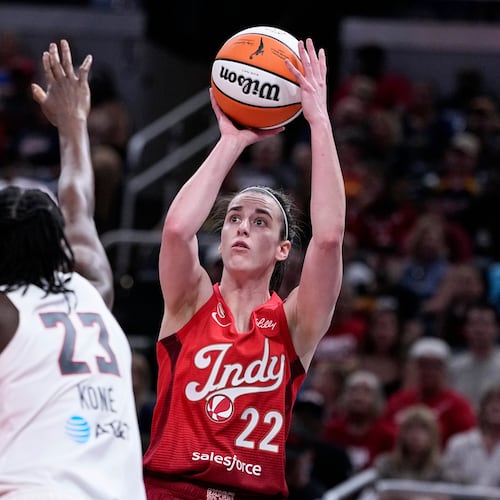 Indiana Fever guard Caitlin Clark (22) shoots over Atlanta Dream forward Sika Kone (23) in the first half of a WNBA basketball game in Indianapolis, Thursday, June 18, 2026. (AP Photo/Michael Conroy)