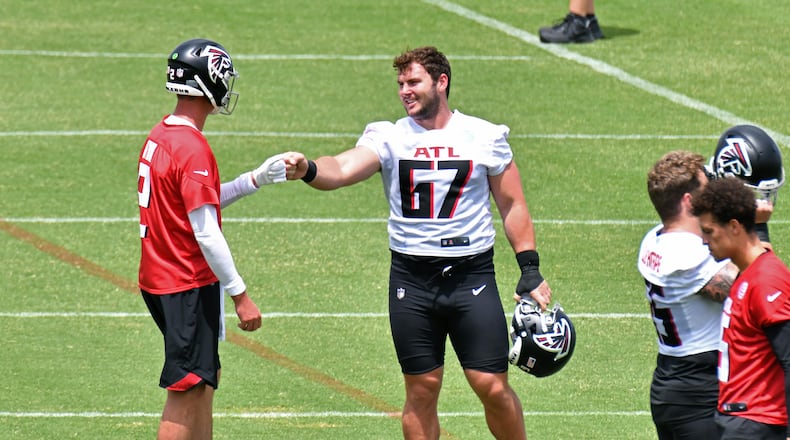 Falcons quarterback Matt Ryan (2) and rookie Drew Dalman (67) exchange fist-bumps during a mandatory minicamp in Flowery Branch on Wednesday, June 9, 2021. (Hyosub Shin / Hyosub.Shin@ajc.com)
