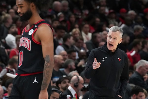 Chicago Bulls head coach Billy Donovan, right, points as he talks to guard Coby White during the first half of an NBA play-in tournament basketball game against the Miami Heat in Chicago, Wednesday, April 16, 2025. (AP Photo/Nam Y. Huh)