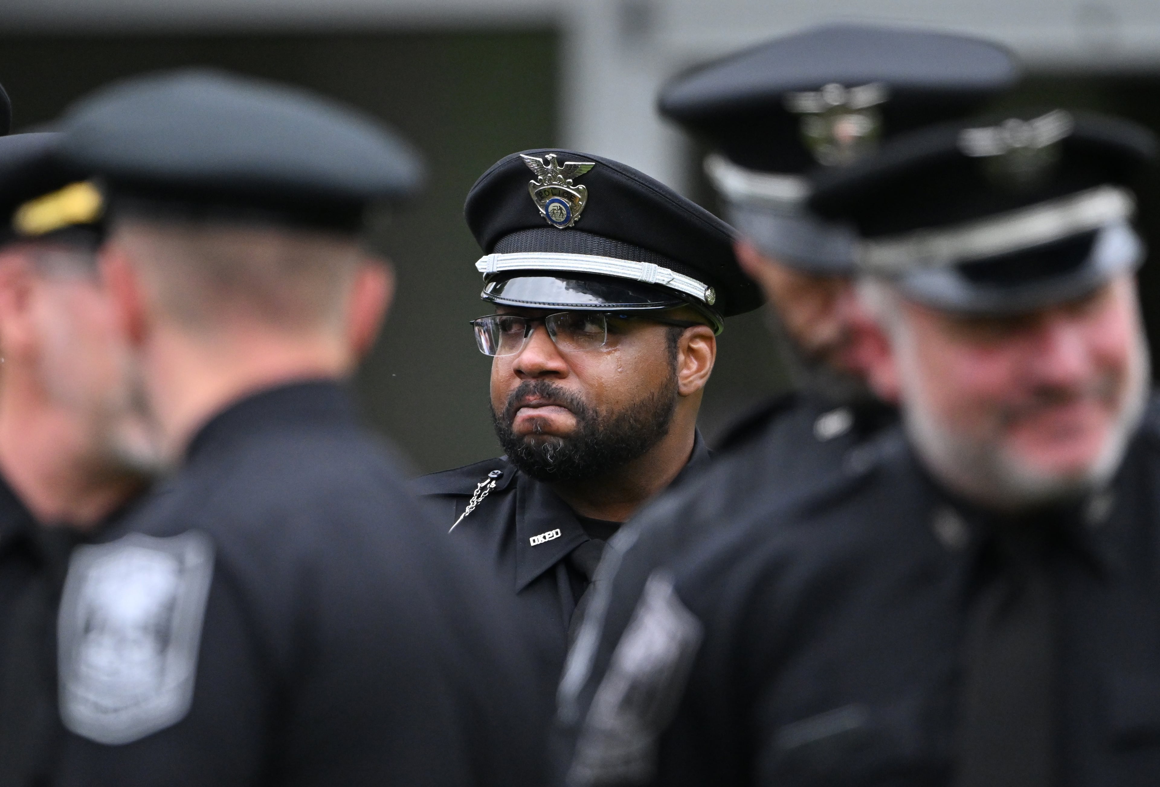A DeKalb County police officer can’t hide his emotional during the Final Honors following the memorial service for DeKalb County police Officer David Rose, who was killed while responding to the Aug. 8 shooting at the CDC, outside the First Baptist Church Atlanta, Friday, August 22, 2025, in Atlanta. Hyosub Shin / AJC)