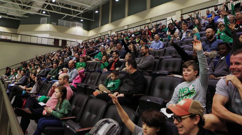 Children raise their hands in a packed house during the Buford City schools’ All Pro Dad Day breakfast, on Tuesday, Jan. 14, 2020, at Buford Arena. All Pro Dad is a program through the nonprofit Family First, whose goal is to get fathers more involved in their children’s lives. CHRISTINA MATACOTTA FOR THE AJC