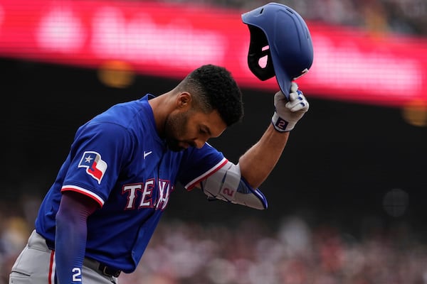 Texas Rangers' Marcus Semien removes his helmet after striking out during the eighth inning of a baseball game against the San Francisco Giants, Sunday, April 27, 2025, in San Francisco. (AP Photo/Godofredo A. Vásquez)