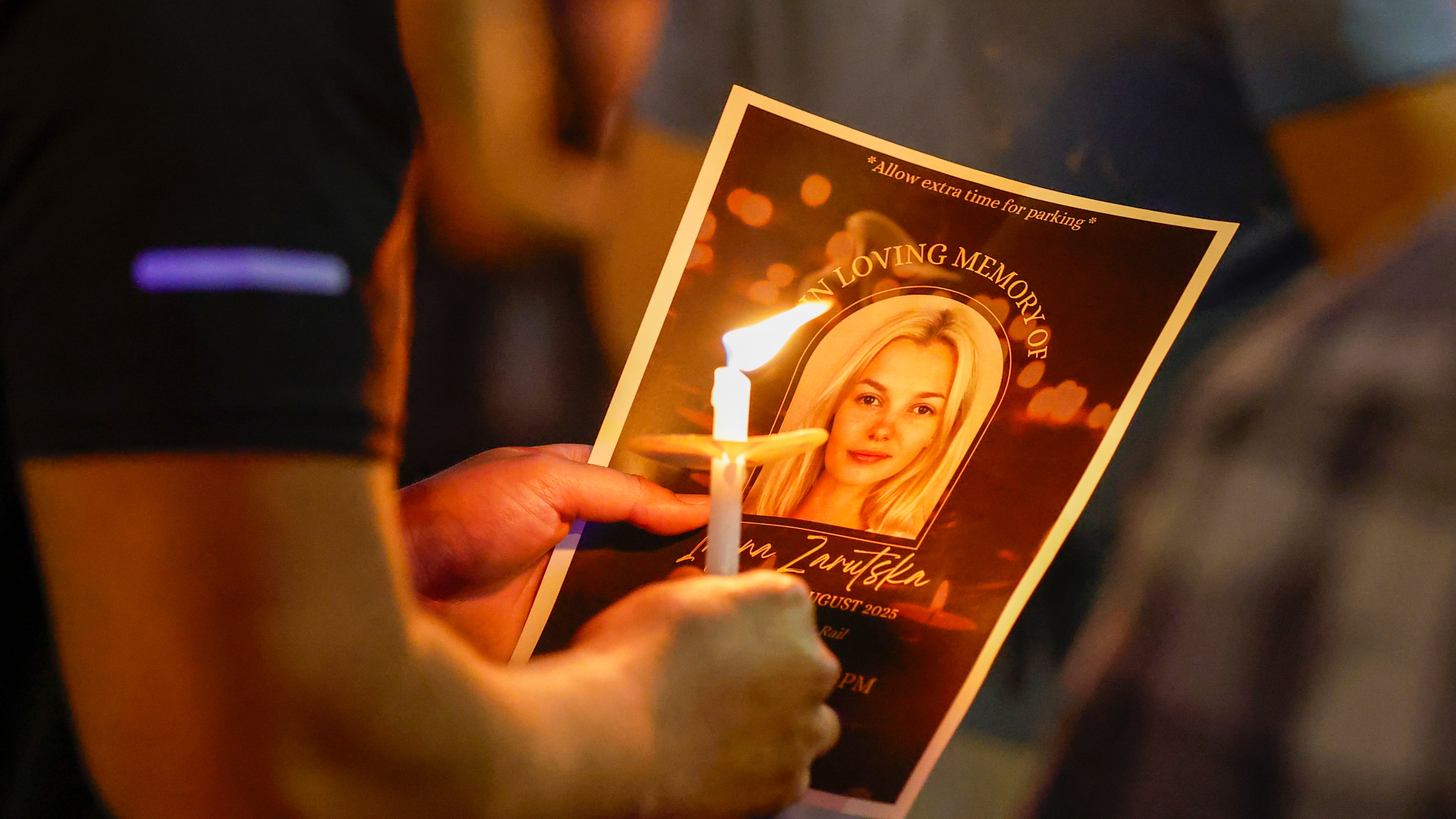 Community members gather for a vigil honoring the life of Iryna Zarutska, who was fatally stabbed on a commuter train last month, Monday, Sept. 22, 2025, in Charlotte, N.C. (AP Photo/Nell Redmond)