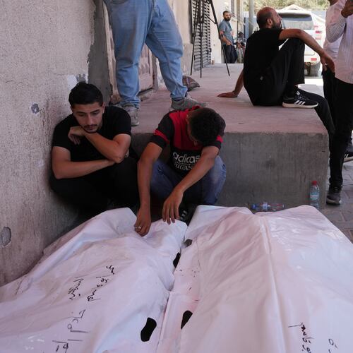 Palestinians mourn the bodies of people killed in an Israeli military strike on a residential building during their funeral at Al-Aqsa Hospital in Deir al-Balah, central Gaza Strip, Wednesday, July 15, 2026. (AP Photo/Abdel Kareem Hana)