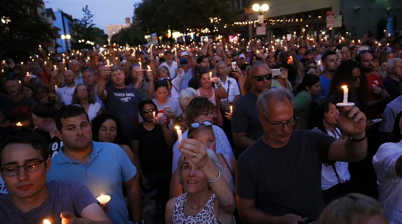 Mourners gather for a vigil at the scene of a mass shooting, Sunday, Aug. 4, 2019, in Dayton, Ohio. Multiple people in Ohio were killed in the second mass shooting in the U.S. in less than 24 hours.