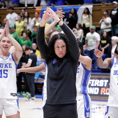 FILE - Duke head coach Kara Lawson, center, and her players celebrate after they defeated Oregon in the second round of the NCAA college basketball tournament Sunday, March 23, 2025, in Durham N.C. (AP Photo/Chris Seward, File)