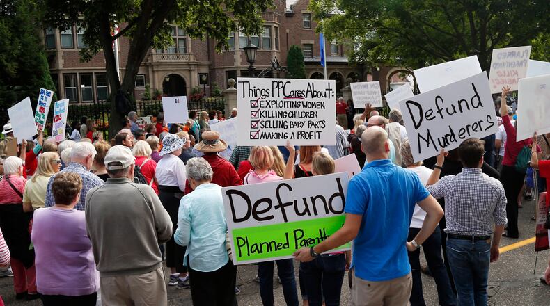 Hundreds of demonstrators gather outside the governor's mansion in St. Paul, Minn., Wednesday in a protest calling for Governor Mark Dayton to defund and investigate Planned Parenthood. (AP Photo / Jim Mone)