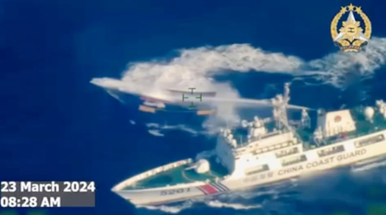 FILE - In this image made from video provided by the Armed Forces of the Philippines, a Chinese coast guard ship uses water cannon on a Philippine resupply vessel Unaizah May 4 as it approaches Second Thomas Shoal, locally called Ayungin shoal, at the disputed South China Sea on March 23, 2024. (Armed Forces of the Philippines via AP, File)