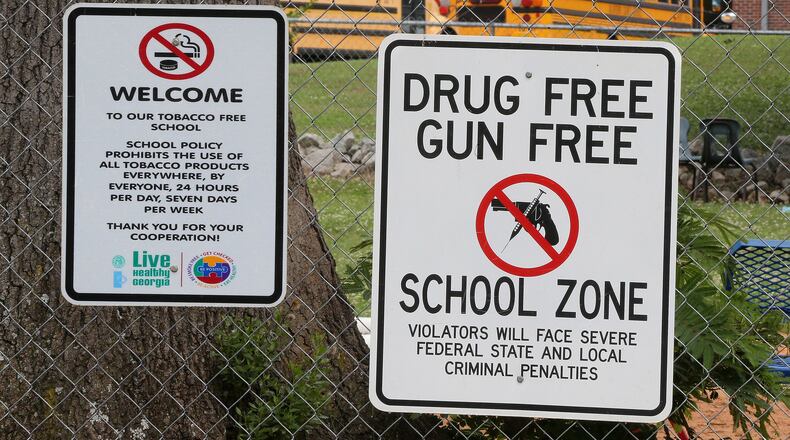 Signs hang on the fence around the Taliaferro County school complex on Wednesday, May 23, 2018, in Crawfordville. Taliaferro County is the state’s smallest school district. Curtis Compton/ccompton@ajc.com