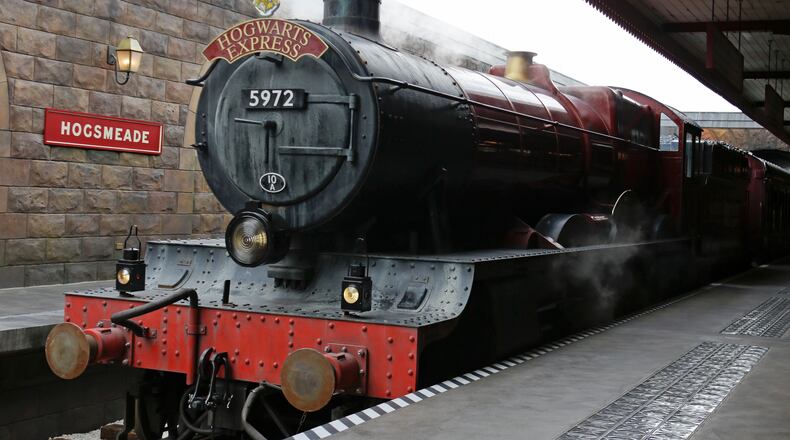 The Hogwarts Express arrives at Hogsmeade station during a preview of Diagon Alley at the Wizarding World of Harry Potter at Universal Orlando, Thursday, June 19, 2014, in Orlando, Fla. (AP Photo/John Raoux)