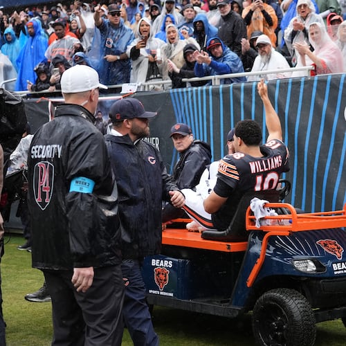 Chicago Bears quarterback Caleb Williams (18) waves as he is carted off the field after an injury during the second half of an NFL football game against the Minnesota Vikings in Chicago, Sunday, Sept. 20, 2026. (AP Photo/Nam Y. Huh)